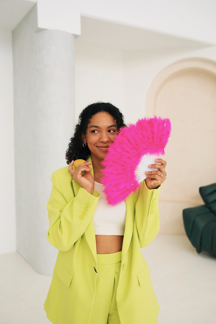 Stylish Woman with Feather Fan and Easter Egg